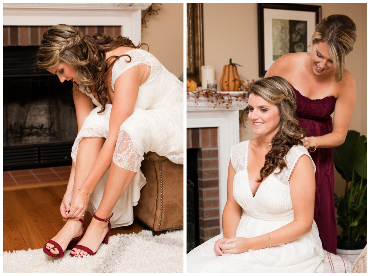 Bride putting her shoes on and bride's sister putting on her necklace