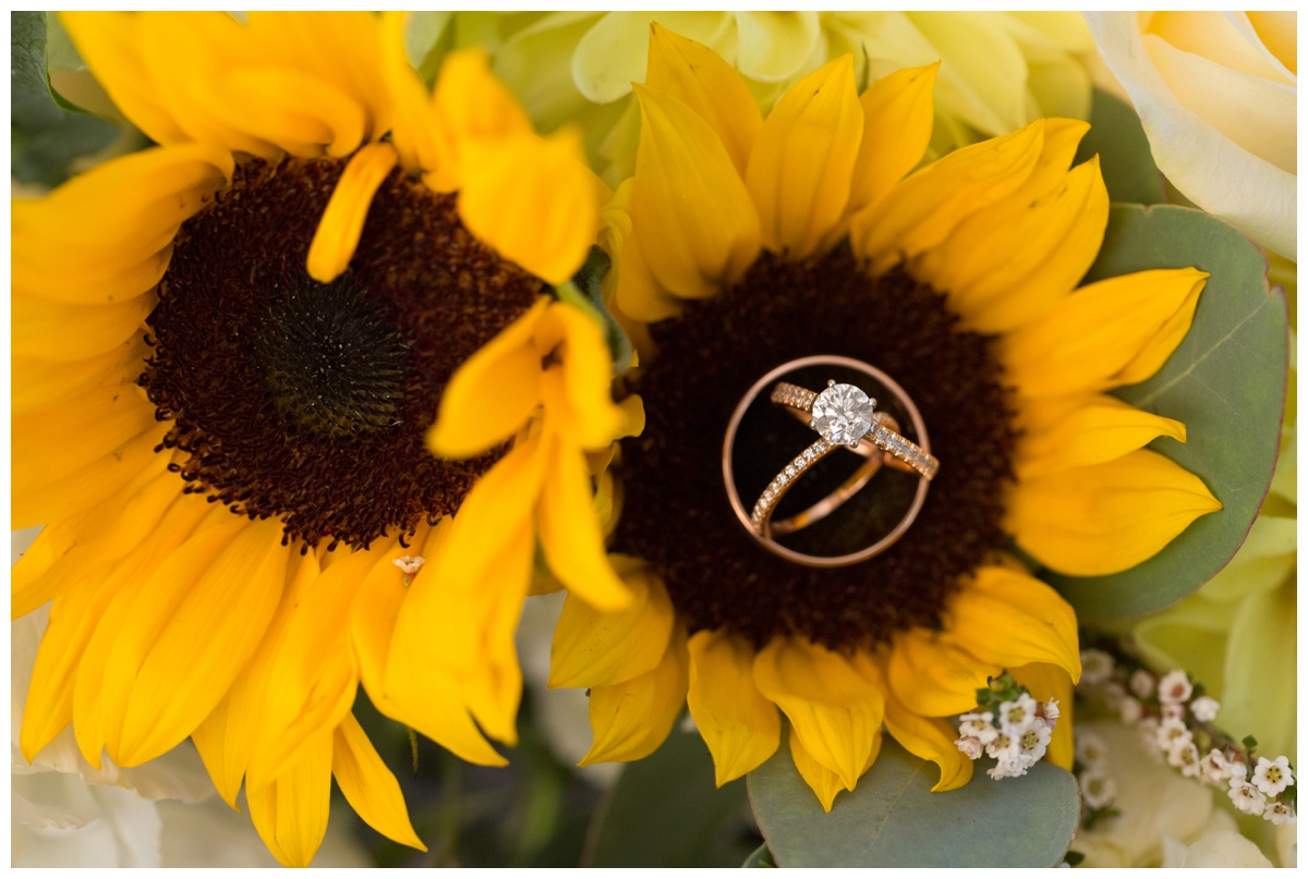 Rose Gold engagement ring and wedding bands on sunflower bouquet