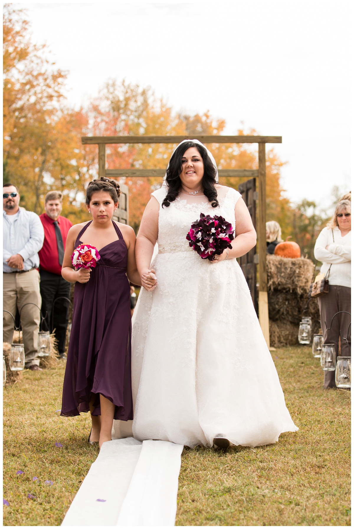 Bride being walked down the aisle by her daughter