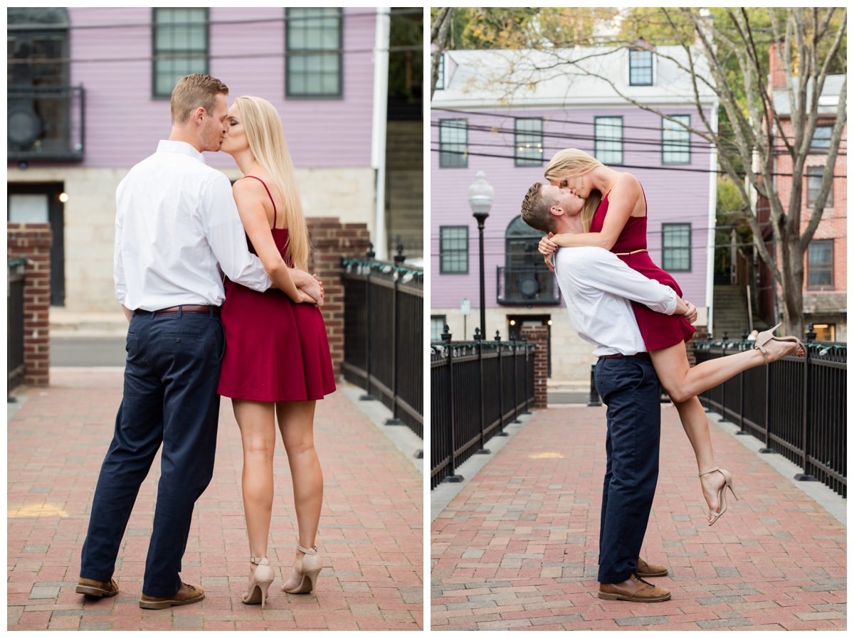 Ellicott City Engagement Photo by train bridge. Old Ellicott City. Lifting and kissing his girl
