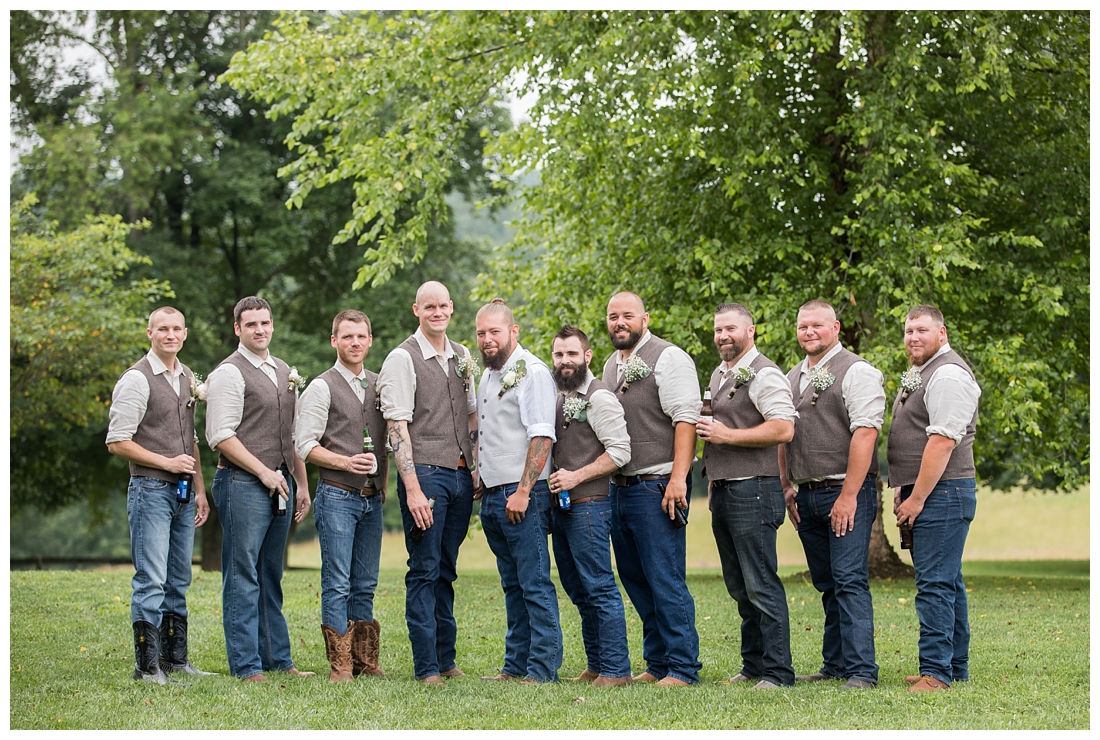 Groomsmen posing in blue heans, cowboy boots and a brown vest. Maryland wedding at Circle D Farm in Woodbine. Maryland Wedding Photographer