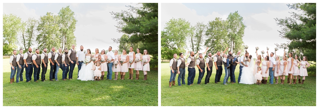 Full bridal party celebrating the newlyweds in a field. Maryland wedding at Circle D Farm in Woodbine. Maryland Wedding Photographer.