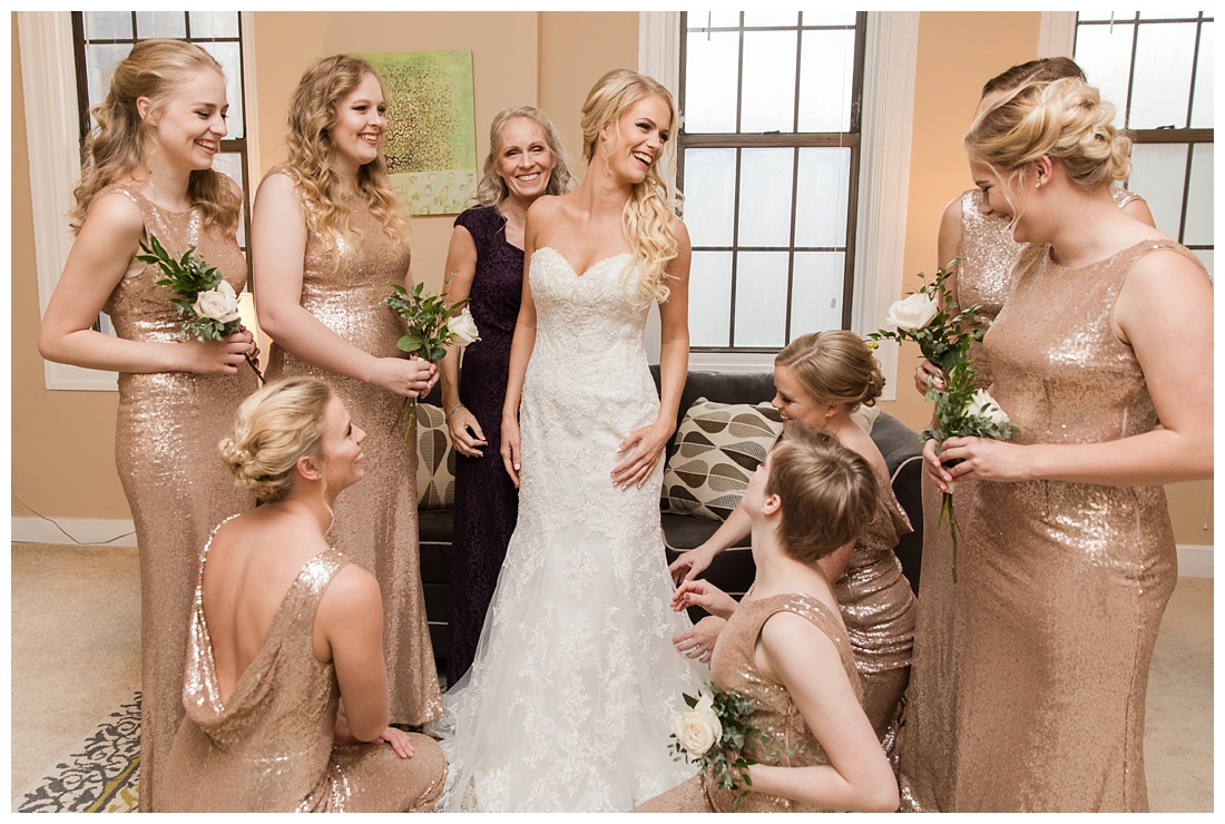 Towson Maryland Catholic Church Ceremony. Joppa Maryland Mountain Branch Golf Club Wedding. The Belvedere bridal wedding preparation. Bridesmaids helping the bride get dressed