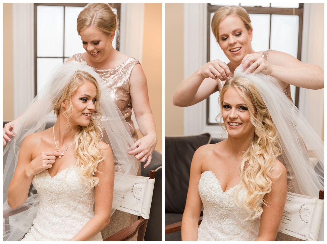 Towson Maryland Catholic Church Ceremony. Joppa Maryland Mountain Branch Golf Club Wedding. The Belvedere bridal wedding preparation. Matron of honor putting the bride's veil on.