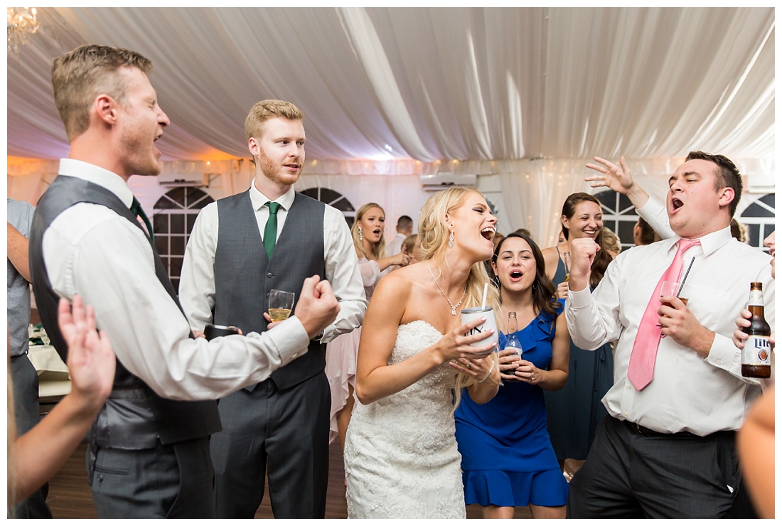 Towson Maryland Catholic Church Ceremony. Joppa Maryland Mountain Branch Golf Club Wedding. The Belvedere bridal wedding preparation.  Wedding reception dancing. Guests on the dance floor singing and dancing