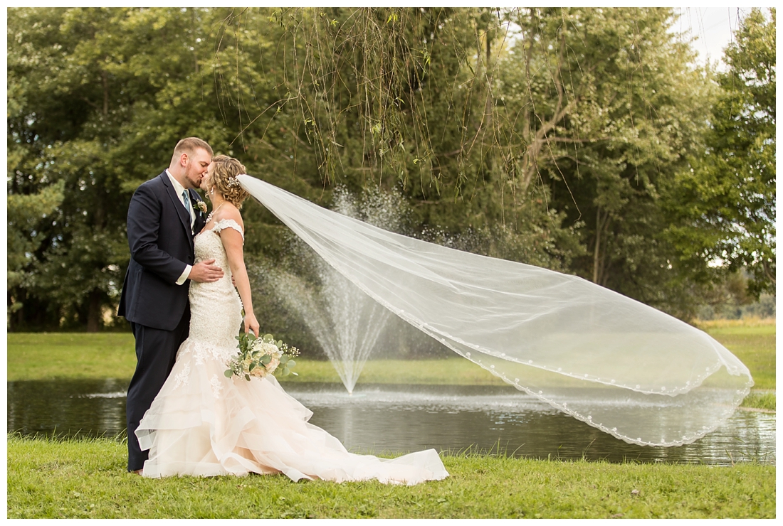 Fall wedding at The Royer House in Westminster Maryland. Cool fall day with dusty blue theme. Carroll County wedding. Cold Wedding day. Windy Wedding. Farm Wedding. bride and groom portraits. Portraits on a farm. fall wedding photos.  veil toss. veil blowing in the wind. 