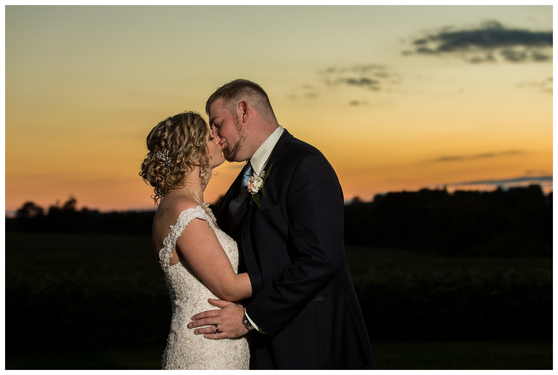 Fall wedding at The Royer House in Westminster Maryland. Cool fall day with dusty blue theme. Carroll County wedding. Cold Wedding day. Windy Wedding. Farm Wedding. Bride and groom at sunset on a farm. Bride and groom kissing. Sunset photos.