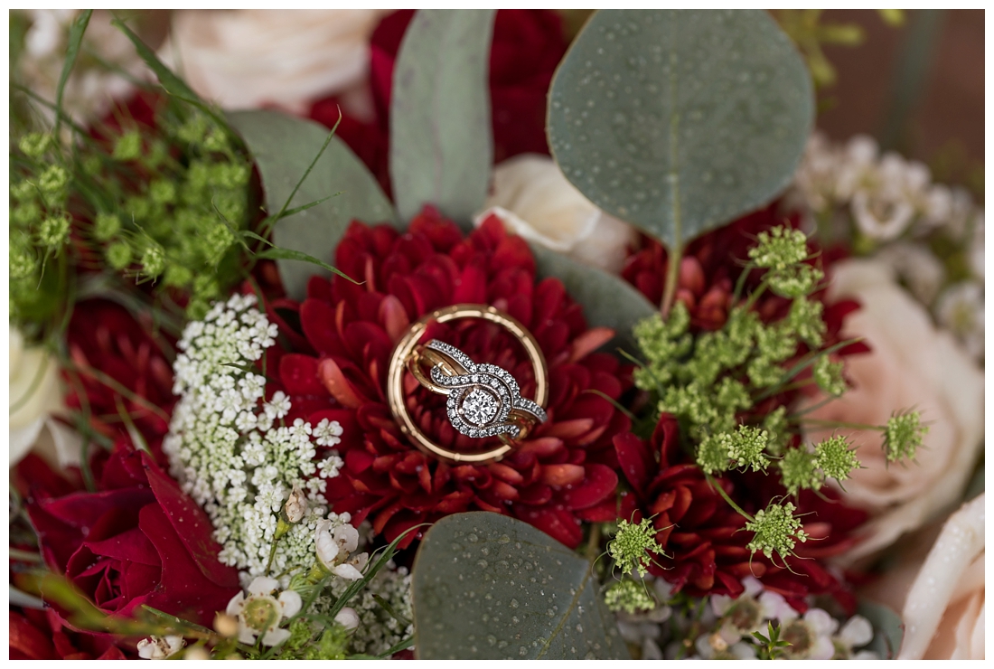 Vineyards of Marys Meadow Wedding in Darlington Maryland. Rainy fall wedding. Cold wedding day. Rainy wedding day. maryland wedding photographer. Barn wedding. Farm Wedding. wedding rings on bride's fall burgundy bouquet.